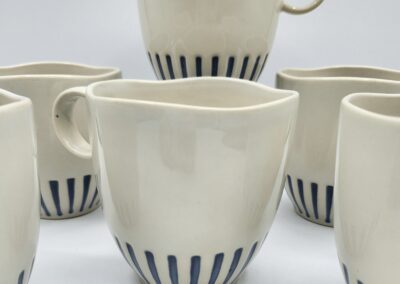 Ceramic mugs with blue striped design.