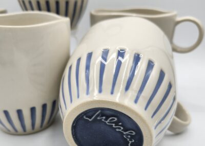 Ceramic mugs with blue striped design.