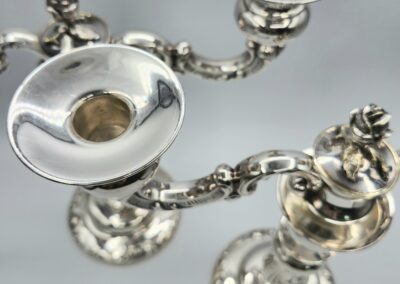 Silver candlesticks with intricate detailing.