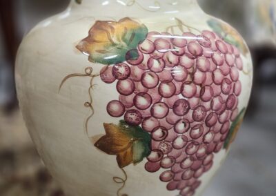 Decorative vase with painted grape design.