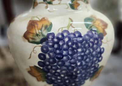 Decorative vase with grape and leaf design.