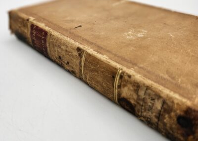 Old, worn book with faded leather cover.