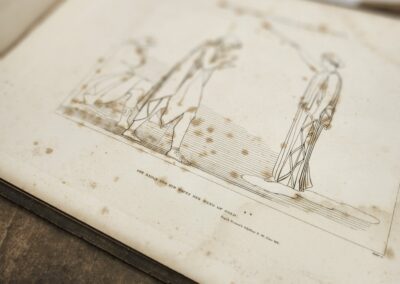 Open book with historical illustration inside.