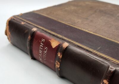 Worn vintage book with dark leather cover.