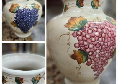 Ceramic vase with grapevine design, close-up.