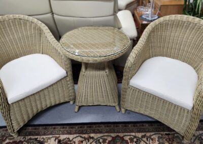 Wicker chairs with cushions and table set.