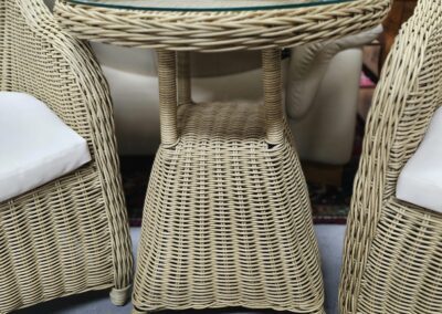 Wicker table with glass top and chairs.