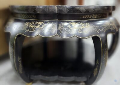 Ornate black table with gold dragon design.