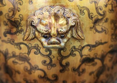 Ornate vase with carved lion head design.