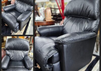 Black leather recliner chair in furniture store.