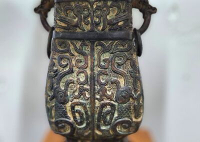 Ornate bronze vase with intricate patterns.