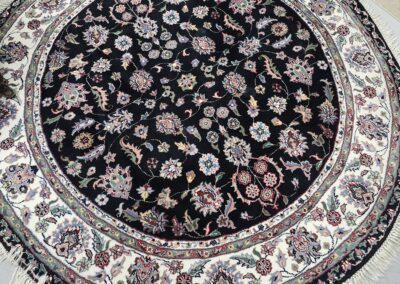 Round floral-patterned rug with intricate details.