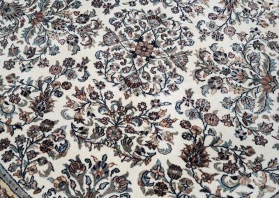 Round floral patterned rug with intricate design.