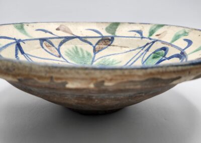Decorative ceramic bowl with blue-green patterns.