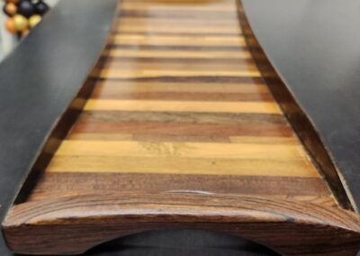 Wooden tray with striped pattern on table.