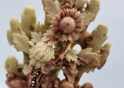 Intricate carved floral sculpture with detailed flowers.