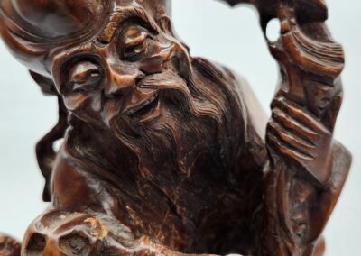 Intricate wooden sculpture of a bearded man.