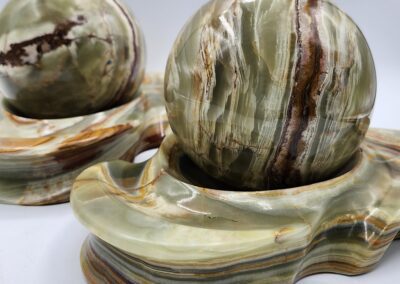 Two polished stone spheres on matching bases.