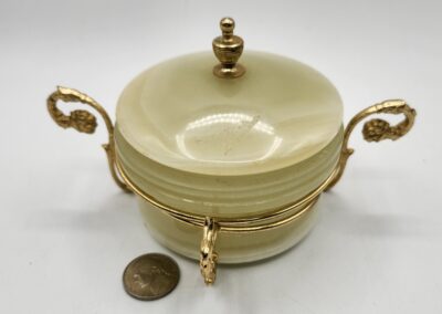 Elegant dish with ornate golden handles.
