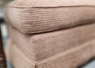 Close-up of a fabric-covered ottoman.