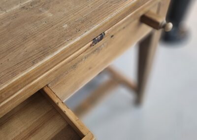 Wooden table with an open drawer.