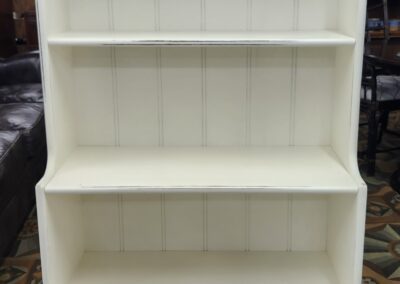 White wooden bookshelf with three shelves.