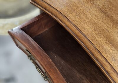 Wooden drawer partially open, elegant design.