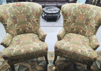 Two ornate patterned armchairs side by side.