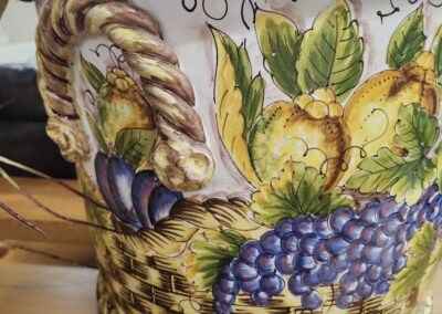 Decorative ceramic pot with fruit design.