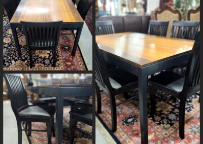 Wooden dining table with black chairs.