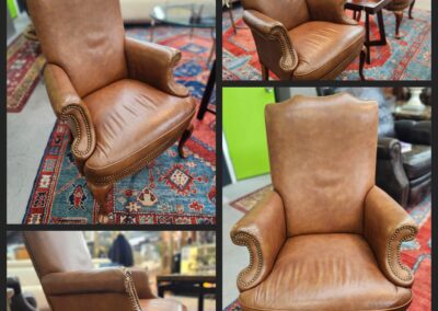 Brown leather armchair with decorative studs.