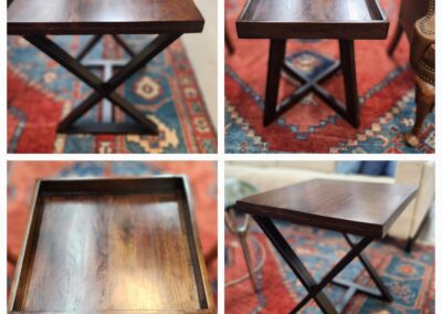 Wooden side table with X-shaped legs.