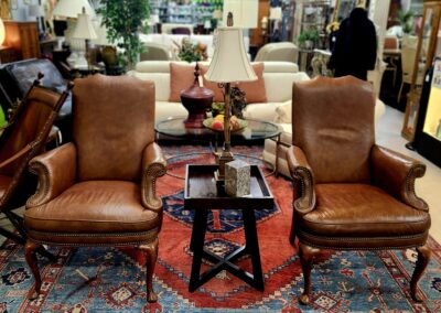 Two leather chairs in a furniture store.