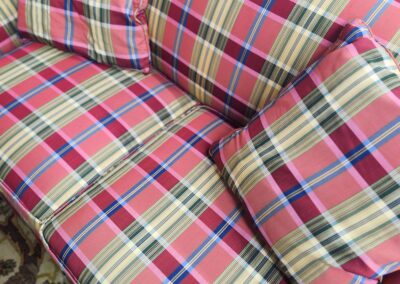 Plaid-patterned sofa with matching cushions.
