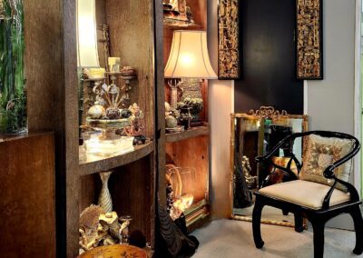 Cozy room with decorative shelves and chair.