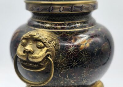 Ornate cloisonné incense burner with lion handles.