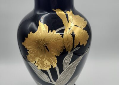 Black vase with gold floral design.