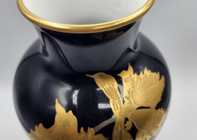 Black vase with gold floral design.