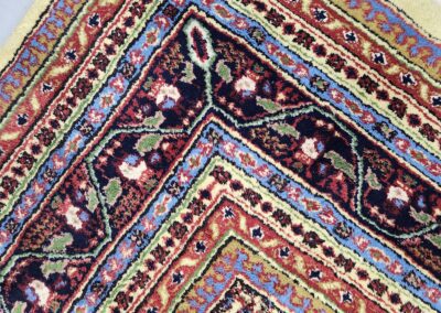 Colorful patterned rug with intricate geometric design.