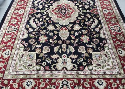 Ornate Persian-style rug with floral patterns.