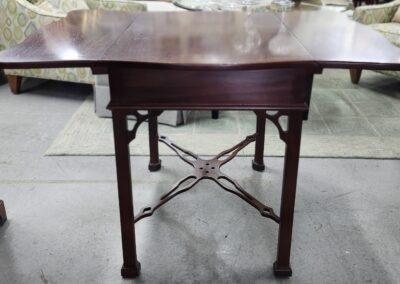 Wooden drop-leaf table in living room.