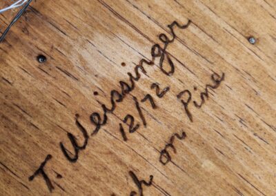 Wood engraving with cursive text and wires.