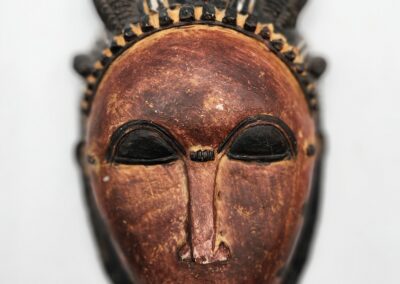 Wooden tribal mask with intricate carved details.