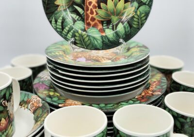 Jungle-themed dinnerware set with giraffes and leopards.