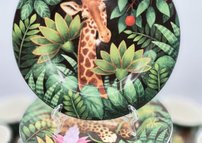 Giraffe-themed plate with jungle foliage design.