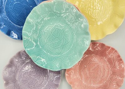 Colorful floral-patterned ceramic plates arranged circularly.