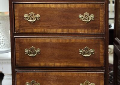Wooden dresser with six drawers and handles.