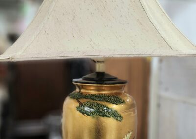 Decorative lamp with bird motif on table.
