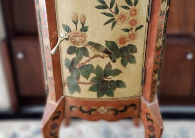 Ornate wooden cabinet with floral design.