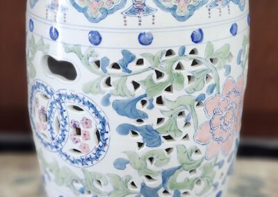 Ornate ceramic garden stool with floral design.